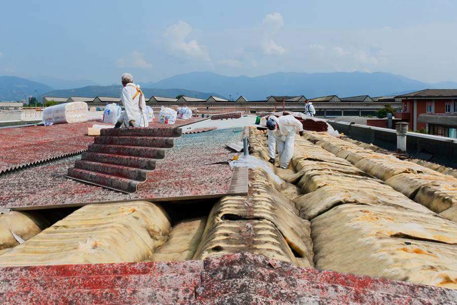 Workers installing insulation on a roof.