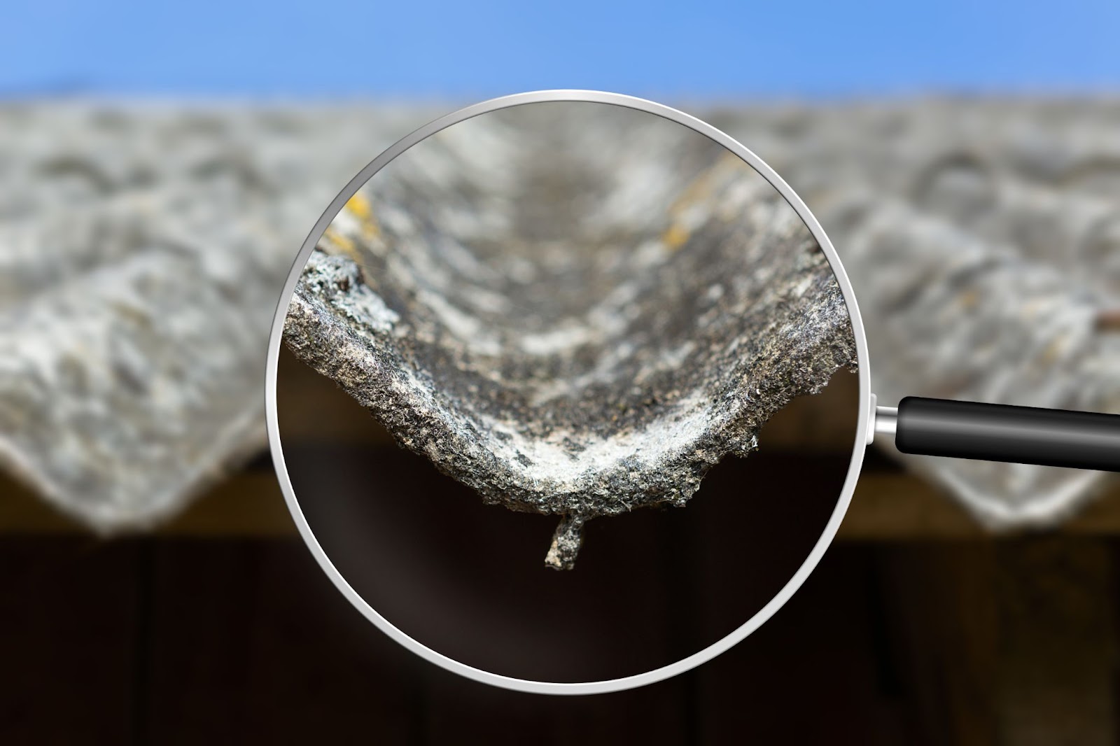 A magnifying glass examines a roof, highlighting concerns about hazardous materials and asbestos removal.